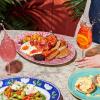 A table of colourful brunch dishes and cocktails